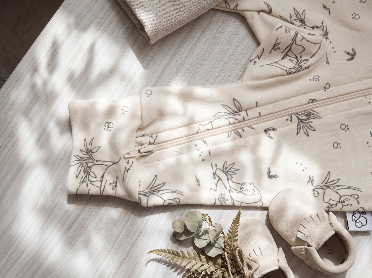 Ribbed cuff and panda print detail of the White Alyssum jumpsuit with baby moccasins