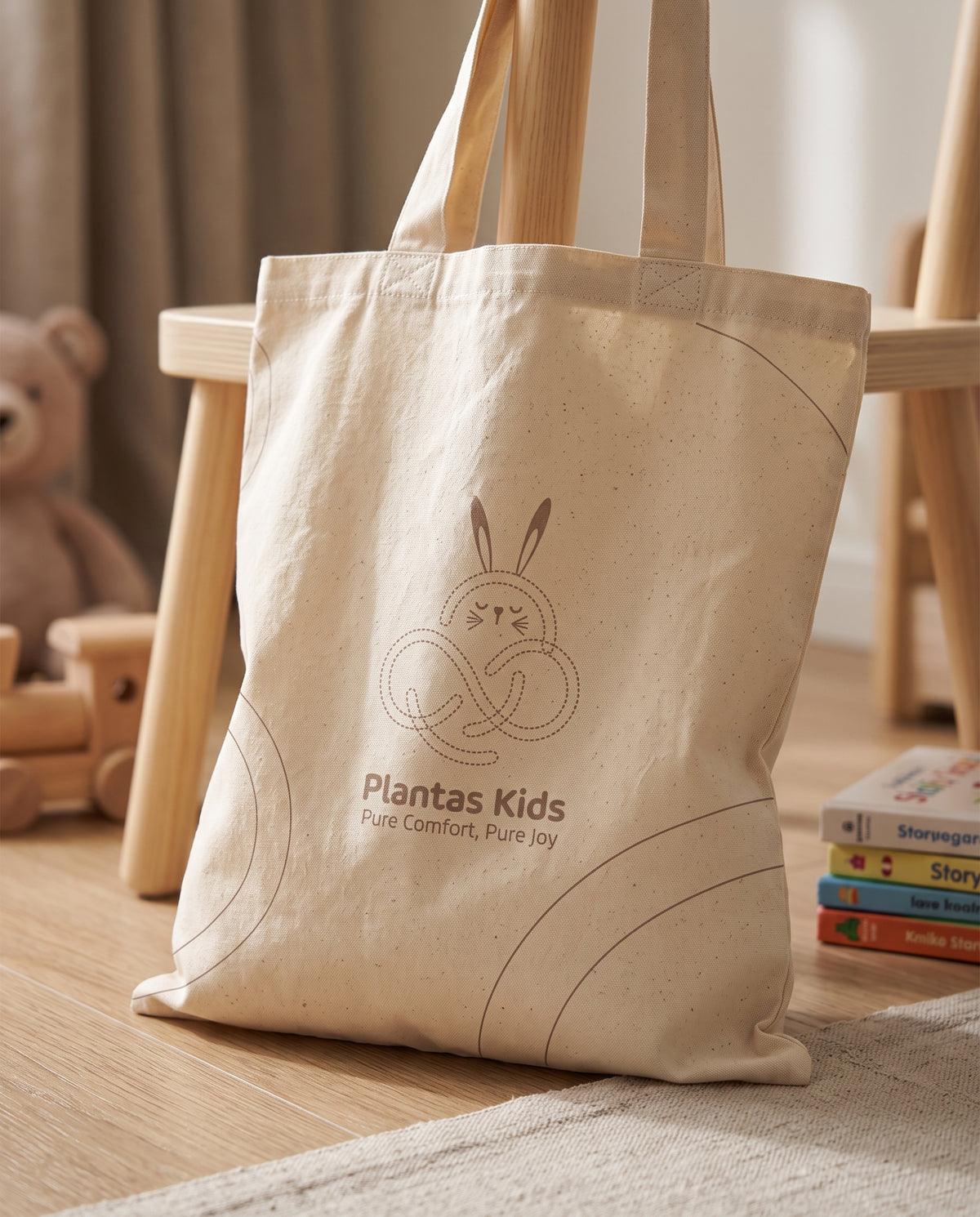 Beige Little Bunny tote bag standing upright, showing the bunny print and handles